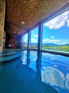 a swimming pool with a view of the mountains at Pousada Dom Xavier in Tiradentes