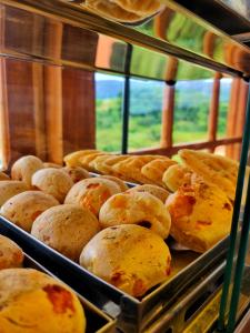 a display case filled with trays of bread at Pousada Dom Xavier in Tiradentes