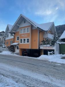 a large building on the side of a snow covered road at Villa Florl in Schladming