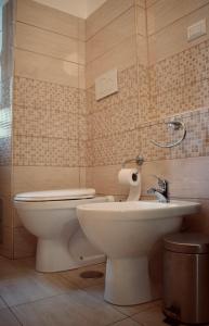 a bathroom with a toilet and a sink at Lavinia Apartment In Trastevere in Rome