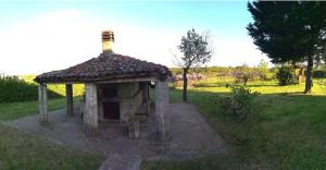 a small house with a roof in a field at AC Ranch in Carentino
