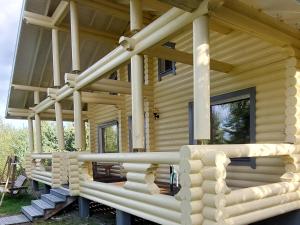 a log cabin with a large front porch at Ollinmäki Vineyard in Anttola