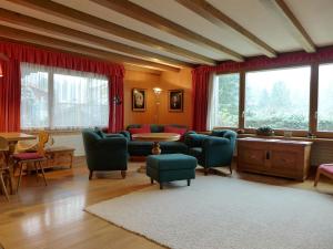 a living room with a couch and chairs and a table at Holiday Home Chalet Marietta by Interhome in Kandersteg
