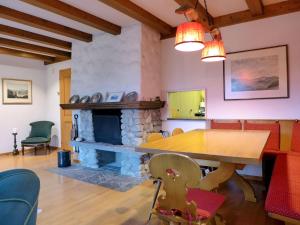 a dining room with a table and a fireplace at Holiday Home Chalet Marietta by Interhome in Kandersteg