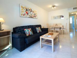 a living room with a couch and a table at Apartment Topacio I by Interhome in Calpe
