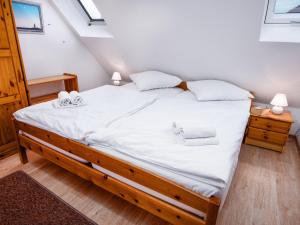 ein Schlafzimmer mit einem großen Bett mit weißer Bettwäsche in der Unterkunft Apartment Blinkfeuer by Interhome in Norddeich