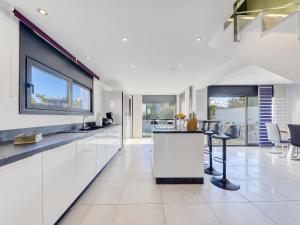 a kitchen with white cabinets and a counter top at Holiday Home Norfeu by Interhome in Empuriabrava