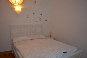 a bedroom with a white bed with stars on the wall at Ferienhaus Ella in Tönning