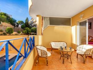 a balcony with chairs and a table on a balcony at Apartment Torrealba by Interhome in Fuengirola