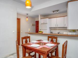 a kitchen with a wooden table and chairs at Apartment Torrealba by Interhome in Fuengirola