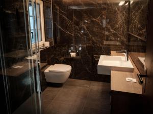 a bathroom with a toilet and a sink at Apartment Kirchplatz by Interhome in Zermatt