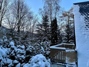 a yard covered in snow next to a house at Holiday Home Gräfenroda by Interhome in Dörrberg