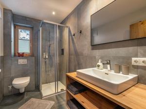 a bathroom with a sink and a shower and a toilet at Apartment Leo-2 by Interhome in Kappl