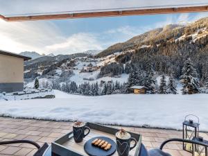 a patio with a view of a snow covered mountain at Apartment Leo-3 by Interhome in Kappl