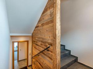 a wooden door with a staircase in a house at Apartment Leo-1 by Interhome in Kappl
