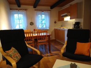 a kitchen and dining room with a table and chairs at FW auf dem Land in Garding