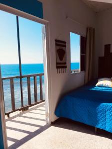 a bedroom with a bed and a view of the ocean at Warm sunset, Loft by the sea in La Libertad
