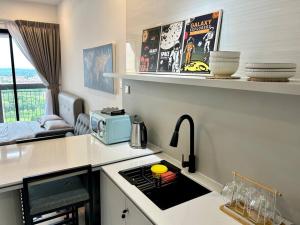 a kitchen with a sink and a stove top oven at HCK14 Sky Tree Dual-key Bukit Indah Aeon/Legoland in Johor Bahru