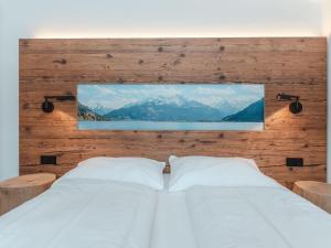 a bedroom with two beds and a view of mountains at Apartment Das Georgen- Kitzsteinhorn by Interhome in Fürstau