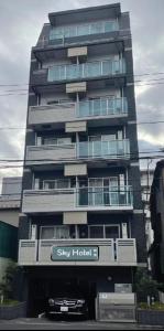 a tall building with a sign in front of it at SkyHotel Ryogoku 駅徒歩4分 in Tokyo