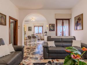 a living room with two couches and a table at Villa Vittoria by Interhome in Bellagio