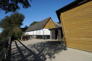 a large white building with a wooden garage at Immensee App H in Ehst