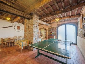 a ping pong table in a living room with a table at Apartment Le Fornaci-1 by Interhome in San Quirico di Moriano