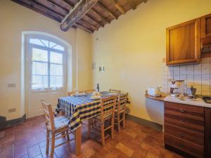a kitchen with a table and chairs in a room at Apartment Le Fornaci-6 by Interhome in San Quirico di Moriano