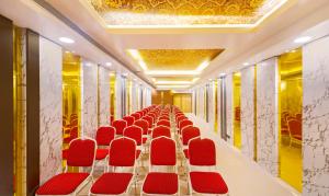 a corridor with red chairs in a room at Treebo Trend Golden Swan Airport Free Pick & Drop in Chennai