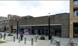 a building with people walking in front of it at Luxe Lodge Woolwich Arsenal in Woolwich