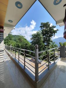 a balcony with a view of the mountains at Nature Villa in Rishīkesh