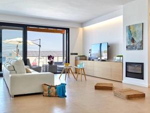 a living room with a white couch and a fireplace at Villa Bellavista in Cala Blava