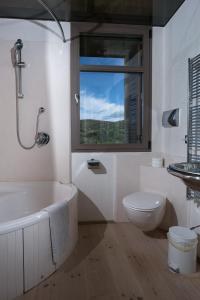 uma casa de banho com uma banheira, um WC e uma janela. em Panama em Roccatederighi
