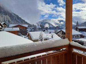a snow covered balcony with a view of a mountain at Apartment Résidence 25 by Interhome in Champex