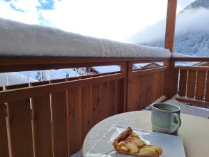 a plate of food sitting on a table on a balcony at Apartment Résidence 25 by Interhome in Champex
