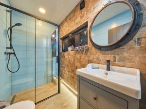 a bathroom with a sink and a mirror at Chalet Lux chalet by Interhome in Mladé Buky