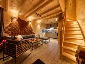 a living room with a couch and a kitchen at Chalet Lux chalet by Interhome in Mladé Buky