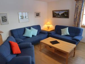 a living room with blue couches and a coffee table at Apartment Tga Stgirat Erdgeschoss by Interhome in Malmigiuer +17 photos