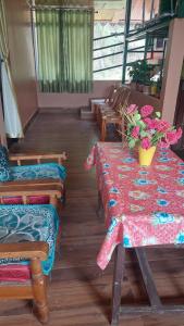 a room with a table and chairs with flowers on it at Athithi homestay in Darjeeling