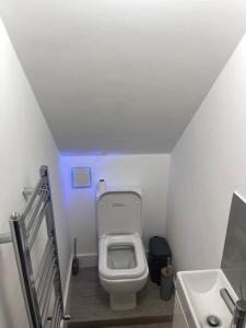 a bathroom with a white toilet and a sink at Mercy 2 in Woolwich