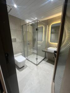 a bathroom with a shower and a toilet and a sink at HOTEL SUPREME (VASCO) in Vasco Da Gama