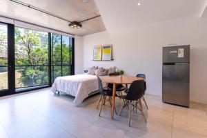 a bedroom with a bed and a table and chairs at NUEVO Loft triple a 5 minutos de Puerto Madero 1A in Buenos Aires