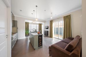 a living room with a couch and a kitchen at Vilnius legends house APARTMENT I Best for families I Free parking in Vilnius