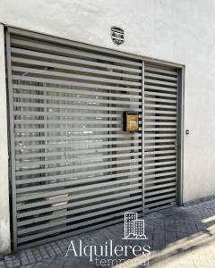 a large metal garage door with a sign on it at suipacha 437 in Rosario