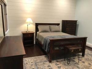 a bedroom with a bed and a table and a lamp at The Cast Iron Lady in Wyalusing