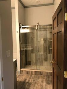 a bathroom with a shower with a glass door at The Cast Iron Lady in Wyalusing