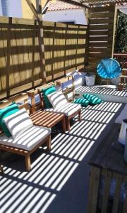a patio with two lounge chairs and an umbrella at Pensao Sisudo in Sintra