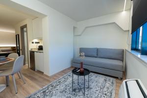 a living room with a couch and a table at Athens Airport Living spaces in Spáta