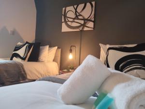 a bedroom with two beds and a painting on the wall at Stay @ The Old Bank Apartments, Burton on Trent in Burton upon Trent +31 photos