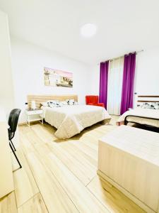 a large bedroom with two beds and purple curtains at Smart House Rooms Luxury in Bergamo